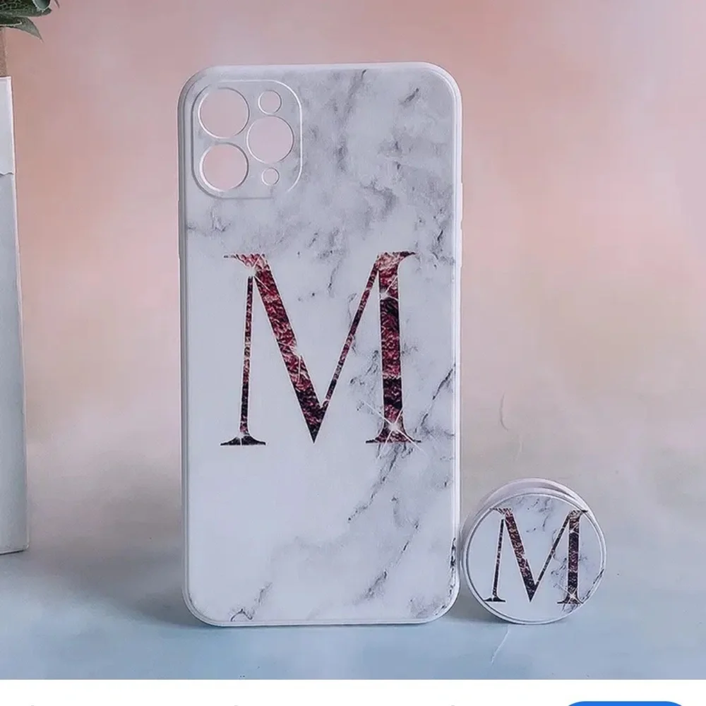 White marble pattern iPhone 13 Pro Max case with a large Rose Gold Letter M